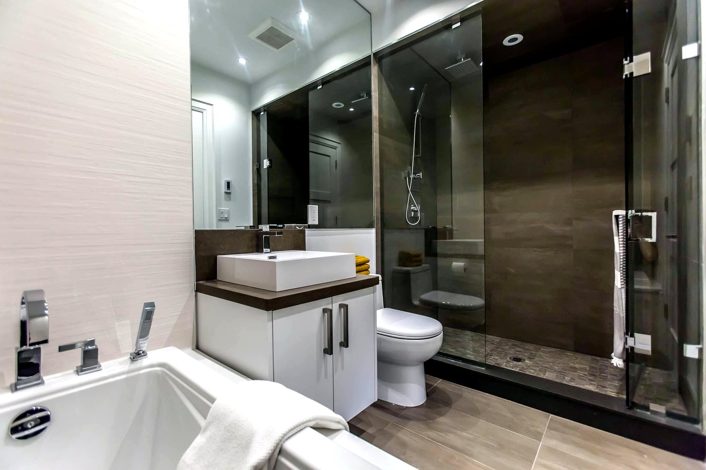 Renovated ensuite bathroom with vessel sink and frameless glass shower