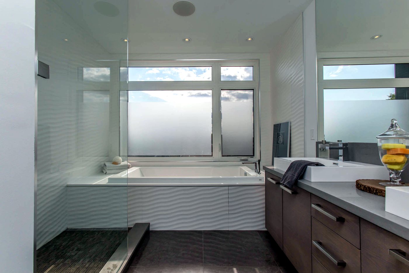 Spa-style bathroom with freestanding soaking tub by the window
