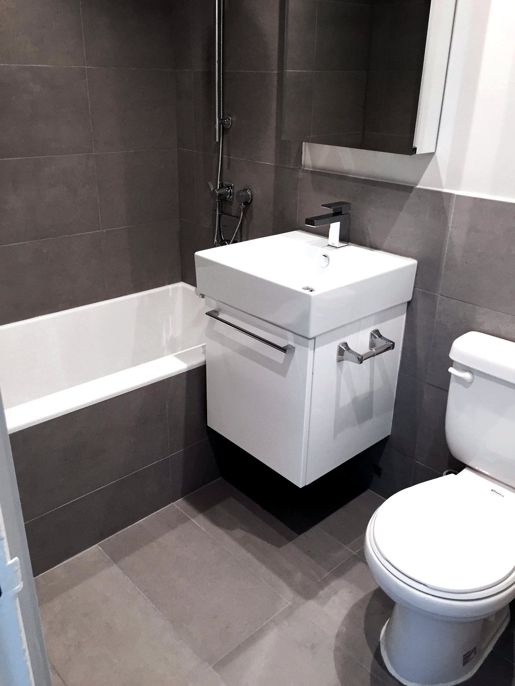 Modern bathroom with floating vanity and large-format tile