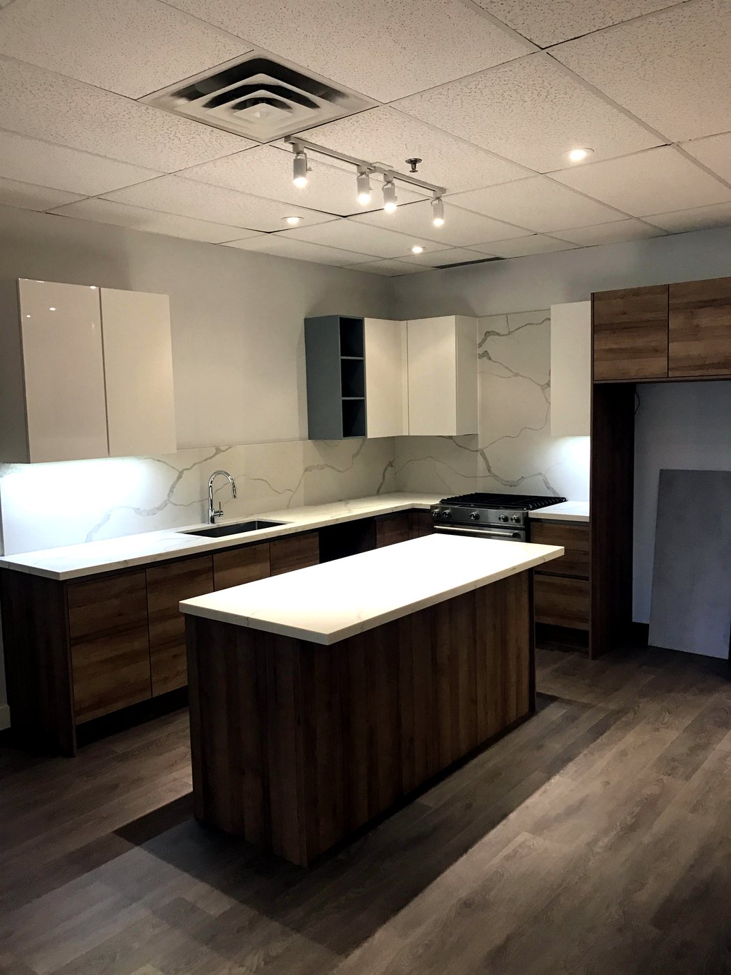 Modern kitchen with waterfall island and full-height stone backsplash